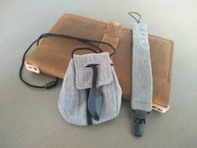 Load image into Gallery viewer, Necklace satchel and clip bracelet in Dusk, with Crazy Horse Leather Journal Cover on gray background.